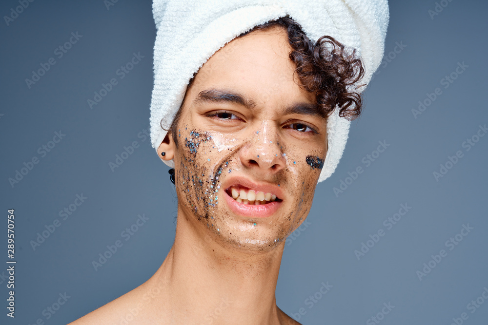 portrait of young man with towel on her head portrait of young man with towel on her head