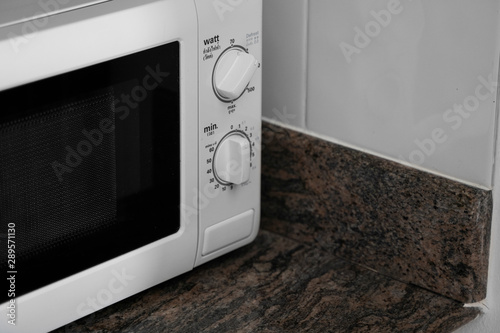 Microwave in a kitchen for cooking or heating a dish.