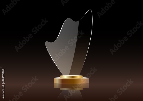 Glass shining golden trophy. Isolated on black.