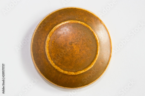 round clay probe with brown glossy glaze.