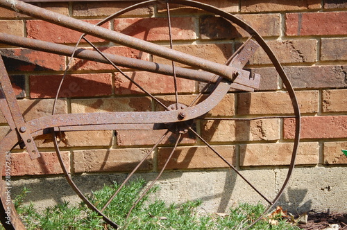 A rusted out wheel from an old farmers plow.