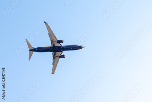 plane flies airplane in blue sky summer