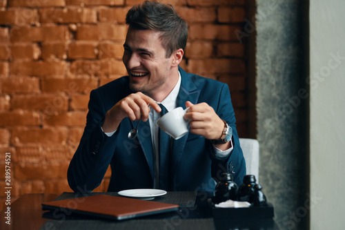 businessman drinking coffee in his office