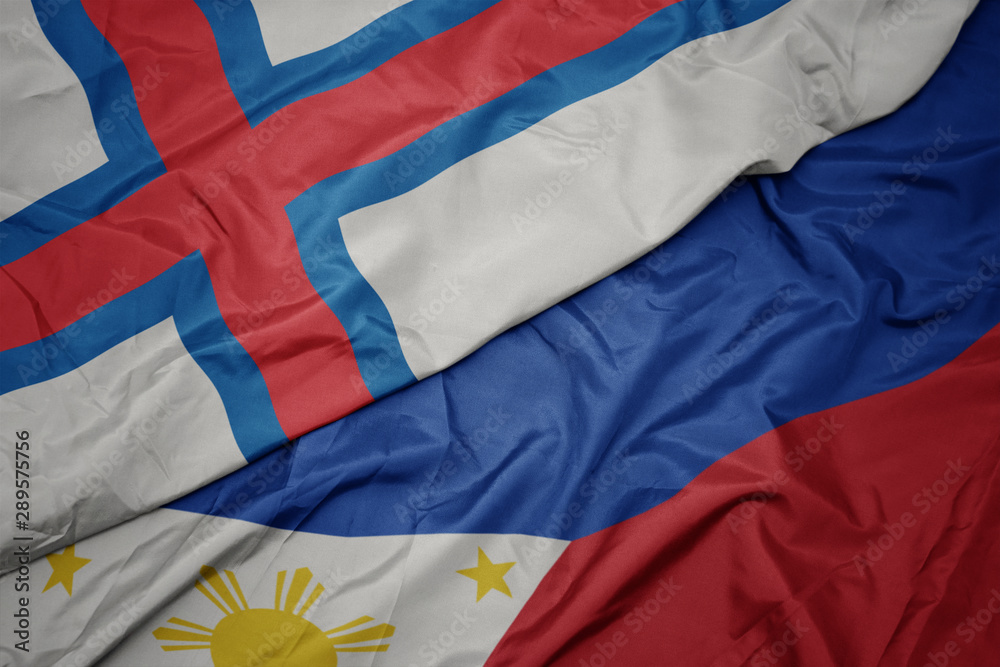 waving colorful flag of philippines and national flag of faroe islands.