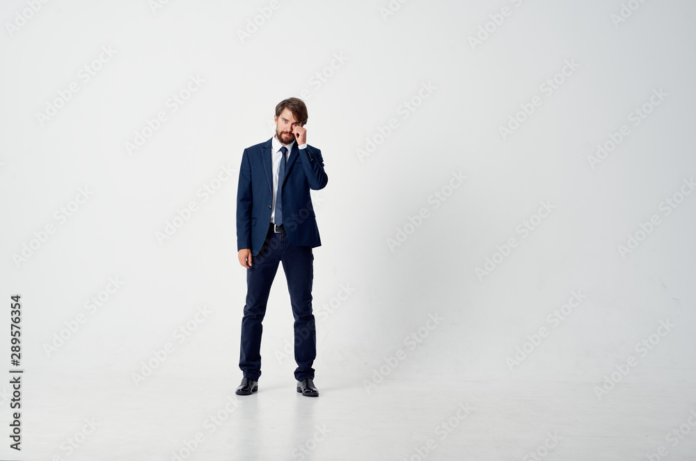 businessman standing in front of a wall businessman standing in front of a wall