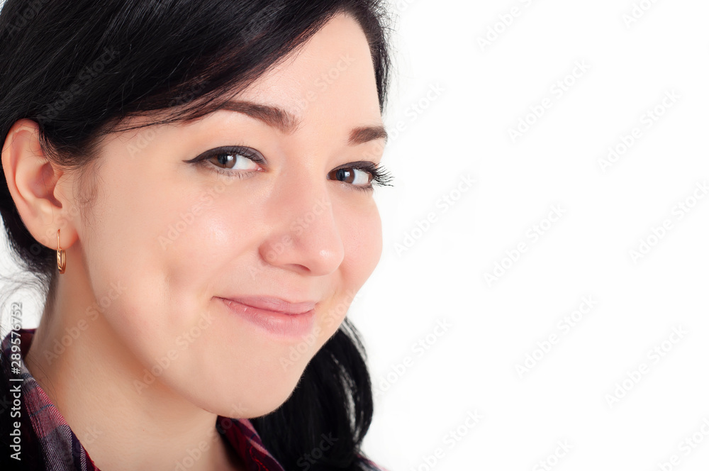 A young joyful beautiful brunette girl with cute dimples on her cheeks smile and looks at the camera with happiness in her eyes. White background. A young joyful beautiful brunette girl with cute dimples on her cheeks smile and looks at the camera with happiness in her eyes. White background.