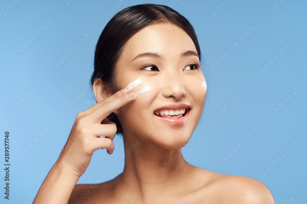 portrait of young woman applying blusher portrait of young woman applying blusher