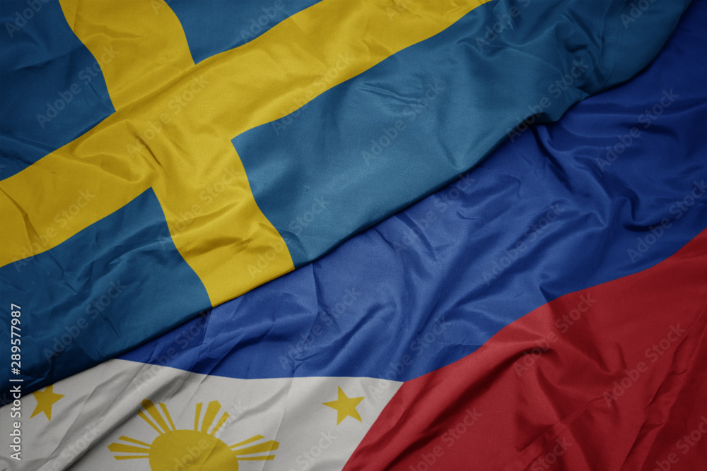 waving colorful flag of philippines and national flag of sweden.