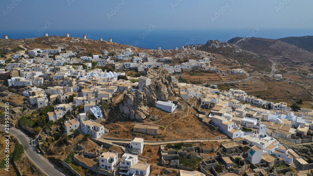 Aerial drone panoramic photo of picturesque main village or chora and castle of Amorgos island built on top of cliff overlooking the Aegean blue sea, Cyclades, Greece
