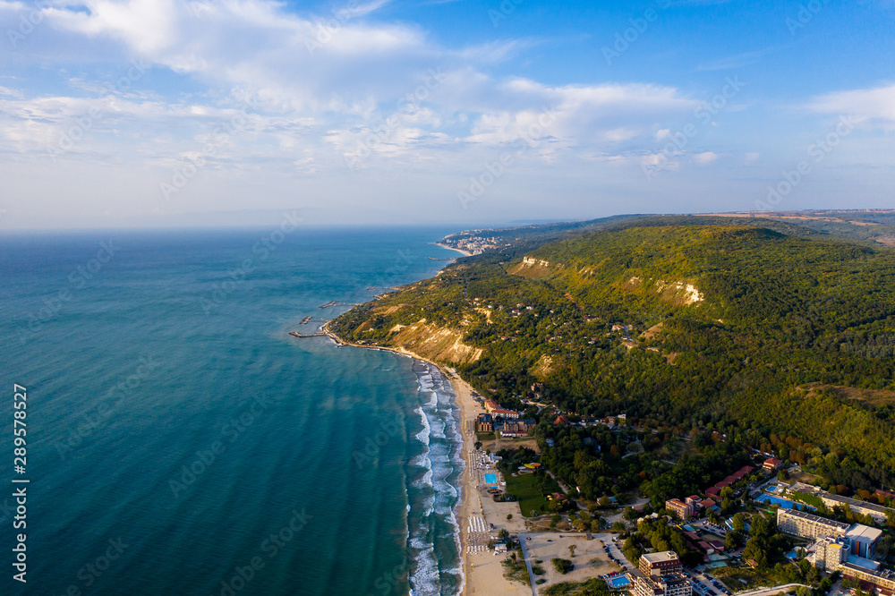 Aerial view of beautiful blue beach with waves and yellow sand