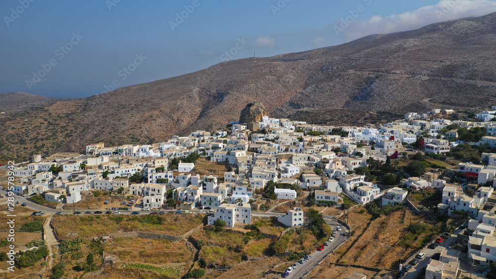 Aerial drone panoramic photo of picturesque main village or chora and castle of Amorgos island built on top of cliff overlooking the Aegean blue sea, Cyclades, Greece