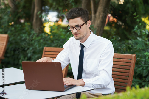 businessman working on his laptop in park