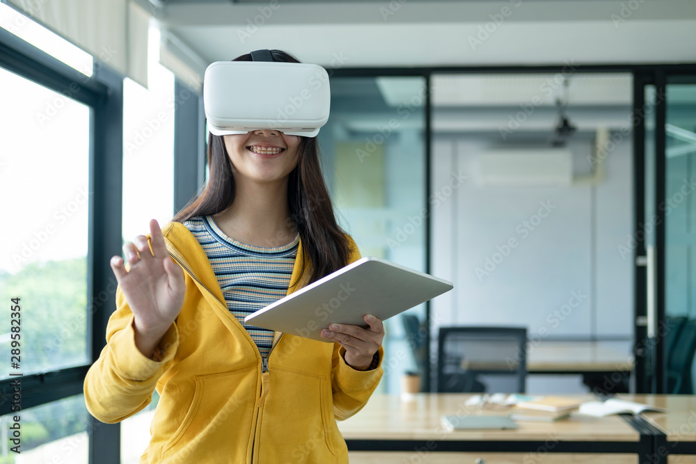 Young programmer with virtual reality glasses to testing 3D application. Young programmer with virtual reality glasses to testing 3D application.