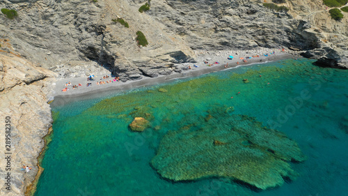 Aerial drone photo of paradise small beach of Mouros with caves and crystal clear sea, Amorgos island, Cyclades, Greece