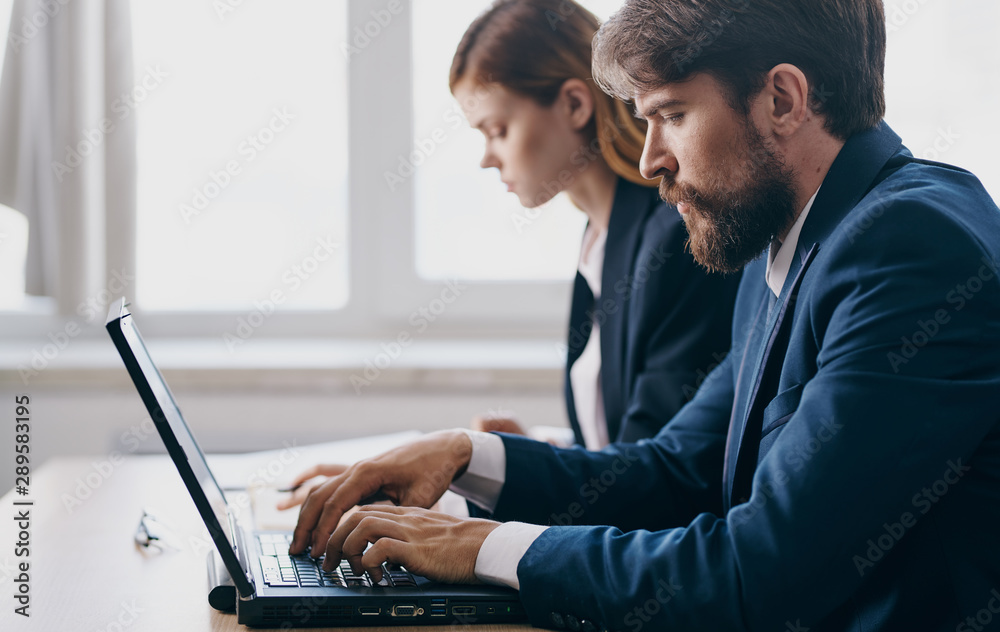 man and woman working in office man and woman working in office