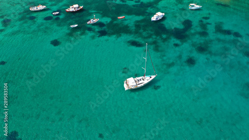 Aerial drone top down photo of traditional docked fishing boats in old port of Mykonos island, Cyclades, Greece