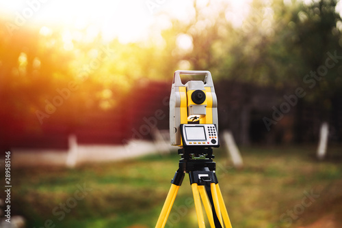 surveyor engineering equipment with theodolite and total station in a garden