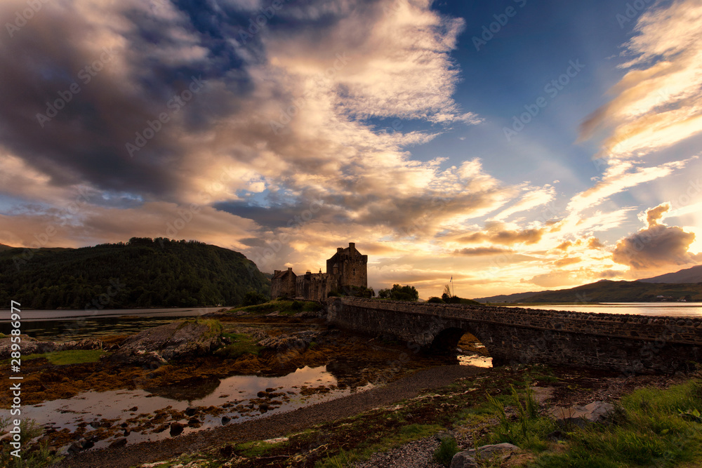 Scottish castle under a cloudy sunset