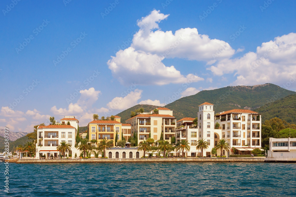 Beautiful view of embankment of Tivat city from sea on sunny summer day. Montenegro, Adriatic Sea