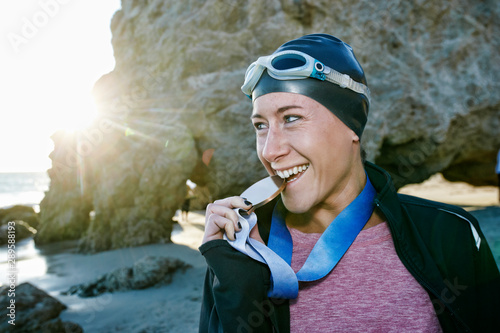 Swimmer on beach with medal