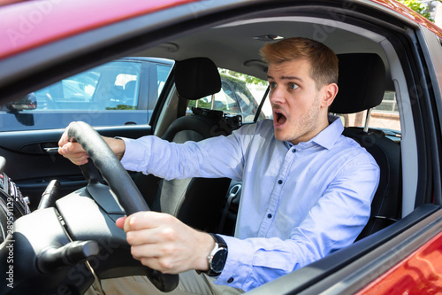 Shocked Young Man Driving Car