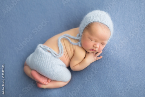 first photo shoot. newborn child. newborn. the child lies on a blue blanket. newborn boy