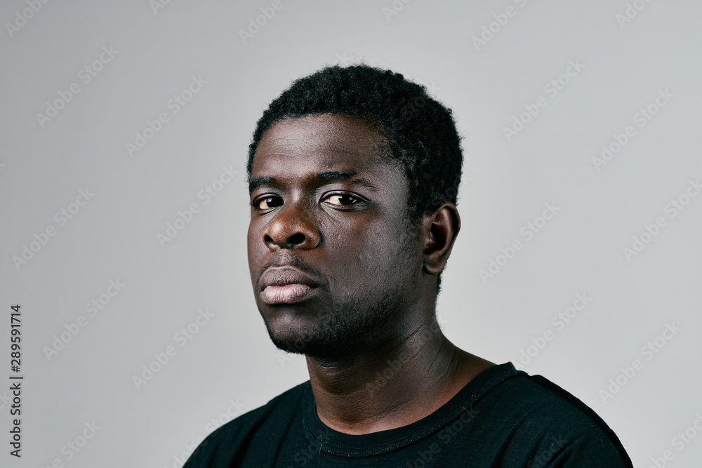 portrait of a young man isolated on black background portrait of a young man isolated on black background