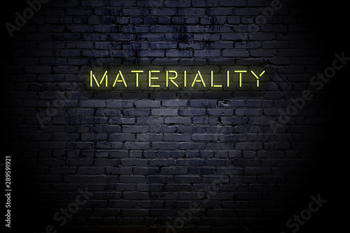 Highlighted brick wall with neon inscription materiality photo