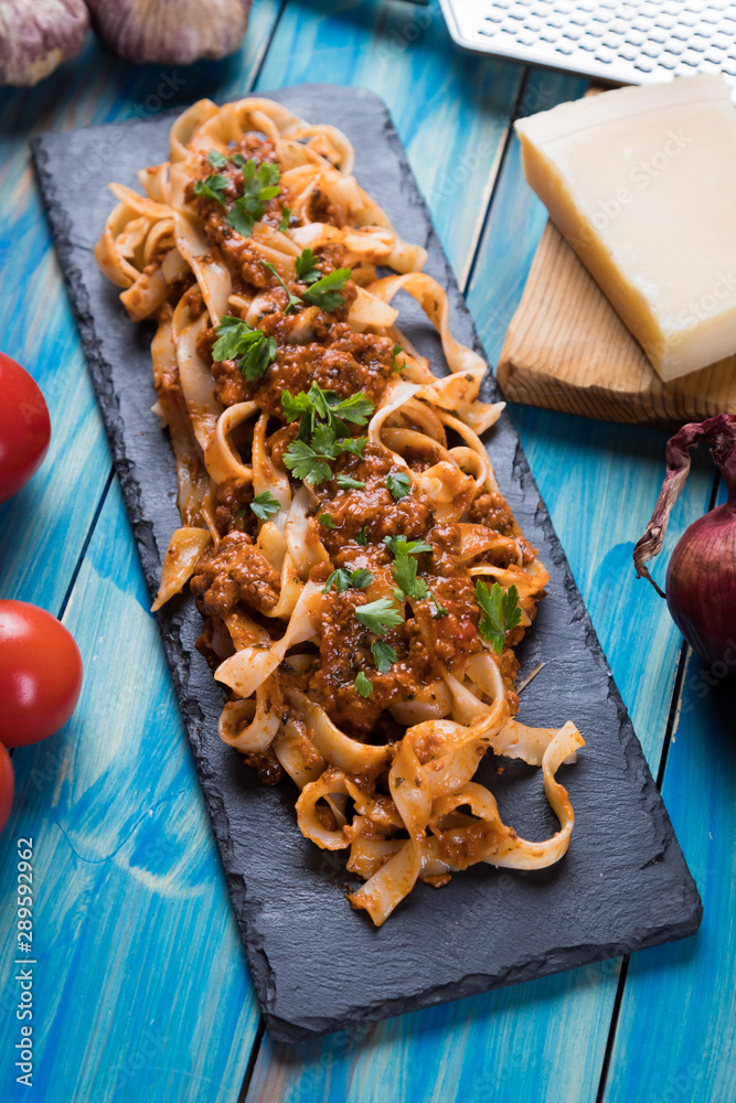 Italian ragu bolognese with flat fettuccine pasta