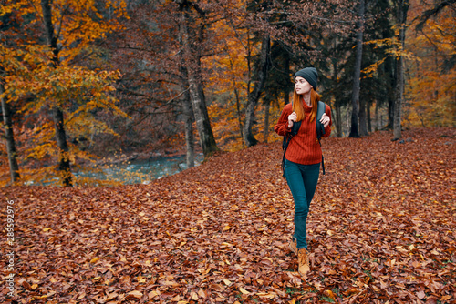 young woman running in autumn forest