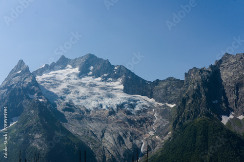 Northern great caucasus mountains near dombay with glaciers and snow in august 2019, original raw picture