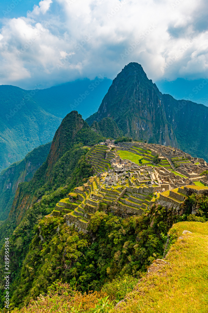 Vertical photograph of the Inca ruin of Machu Picchu, Cusco region, Peru. - obrazy, fototapety, plakaty 