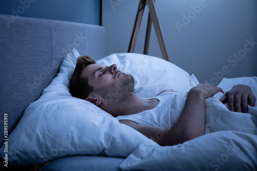 Young Man Sleeping In Bed