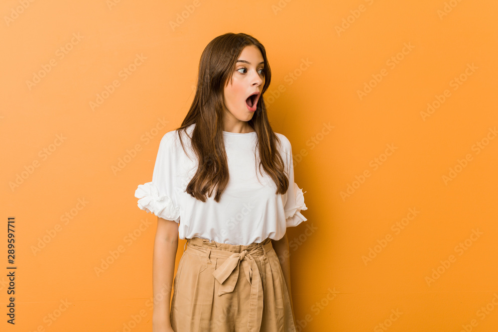 Young caucasian woman being shocked because of something she has seen.
