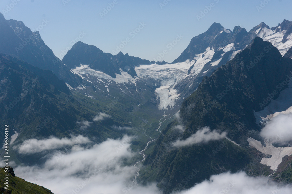 Fototapeta premium Northern great caucasus mountains near dombay with glaciers and snow in august 2019, original raw picture