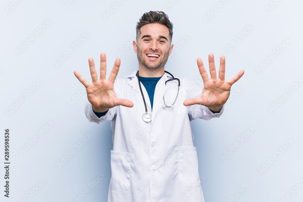 Young handsome doctor man showing number ten with hands. Young handsome doctor man showing number ten with hands.