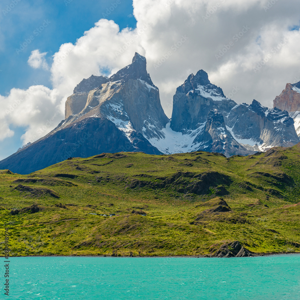 The majestic Cuernos del Paine granite peaks in the background of the turquoise colored Pehoe Lake, Torres del Paine national park, Patagonia, Chile.