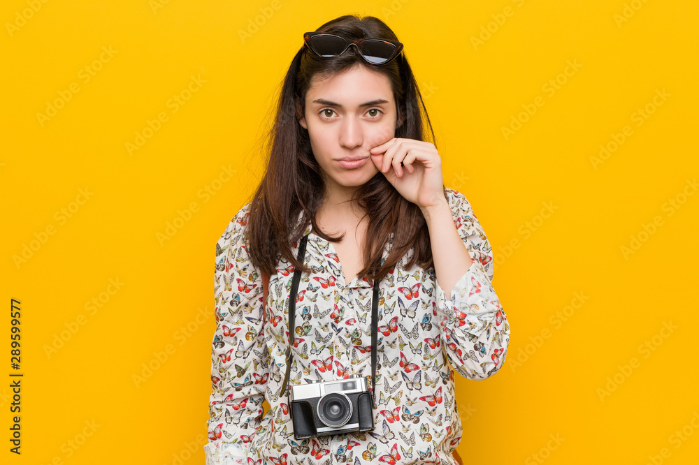 Young brunette traveler woman with fingers on lips keeping a secret. Young brunette traveler woman with fingers on lips keeping a secret.