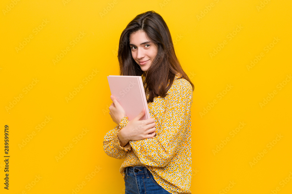 Young caucasian woman holding some notebooks Young caucasian woman holding some notebooks