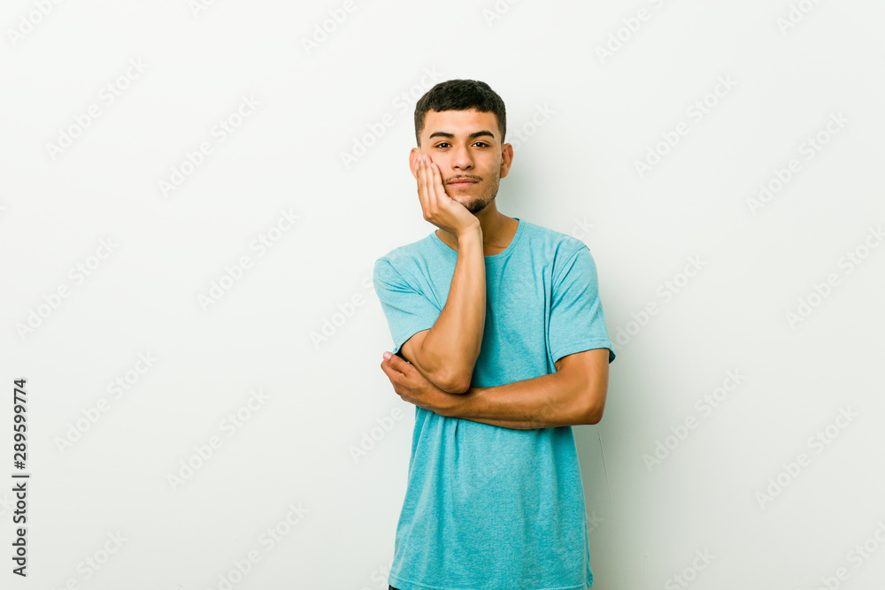 Young hispanic man who is bored, fatigued and need a relax day.