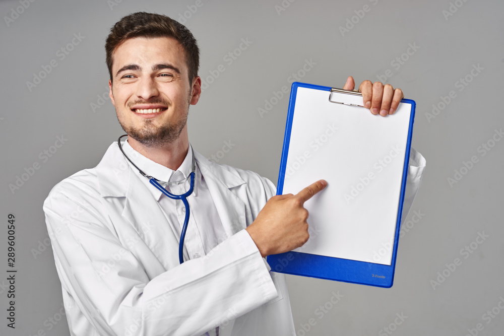young doctor with blank clipboard young doctor with blank clipboard