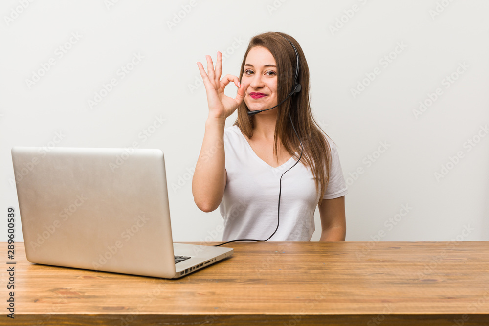 Young telemarketer woman cheerful and confident showing ok gesture. Young telemarketer woman cheerful and confident showing ok gesture.