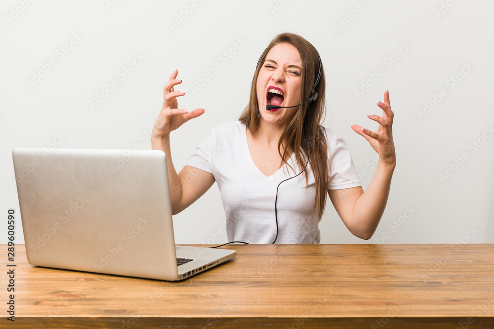 Young telemarketer woman screaming with rage. Young telemarketer woman screaming with rage.