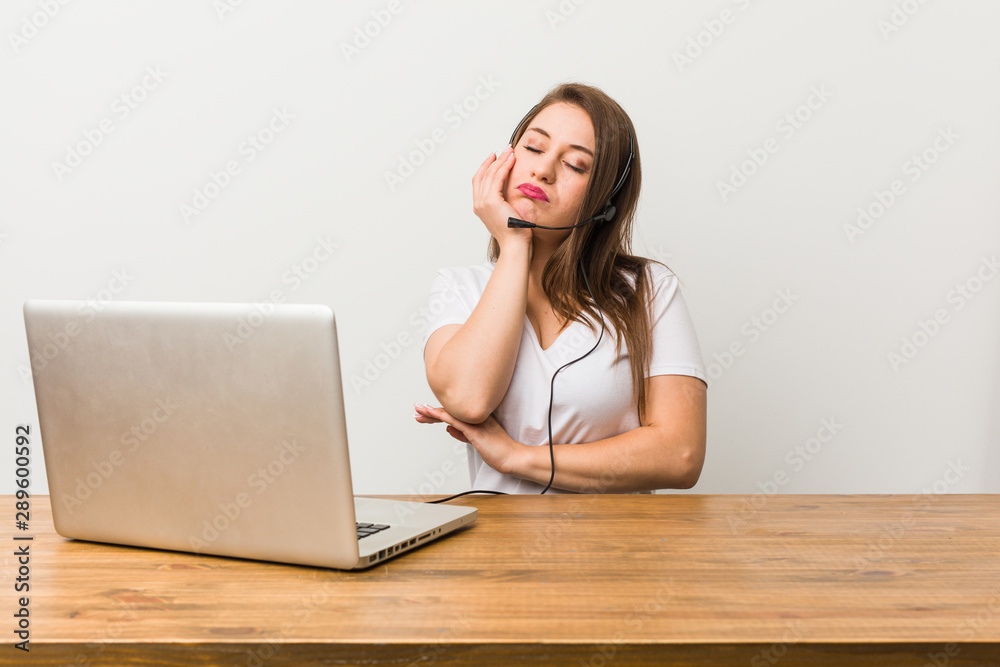 Young telemarketer woman who is bored, fatigued and need a relax day. Young telemarketer woman who is bored, fatigued and need a relax day.