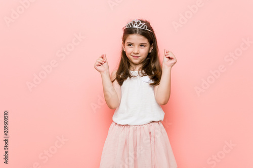 Little girl wearing a princess look showing that she has no money.
