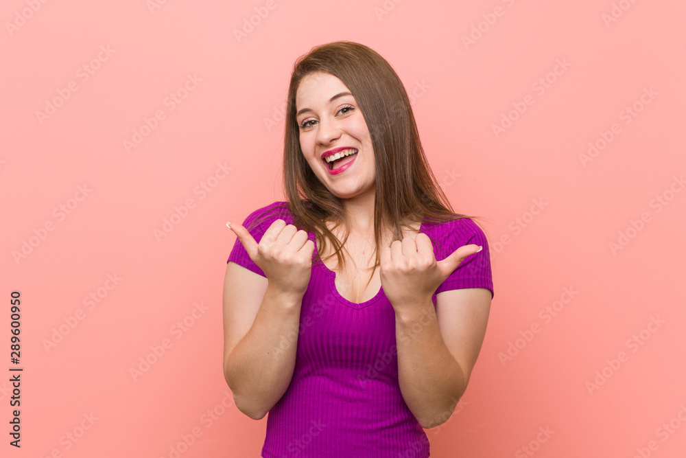 Young hispanic woman against a pink wall raising both thumbs up, smiling and confident. Young hispanic woman against a pink wall raising both thumbs up, smiling and confident.