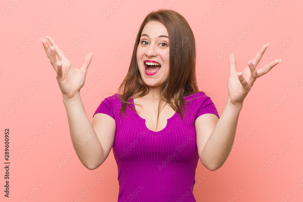 Young hispanic woman against a pink wall receiving a pleasant surprise, excited and raising hands. Young hispanic woman against a pink wall receiving a pleasant surprise, excited and raising hands.
