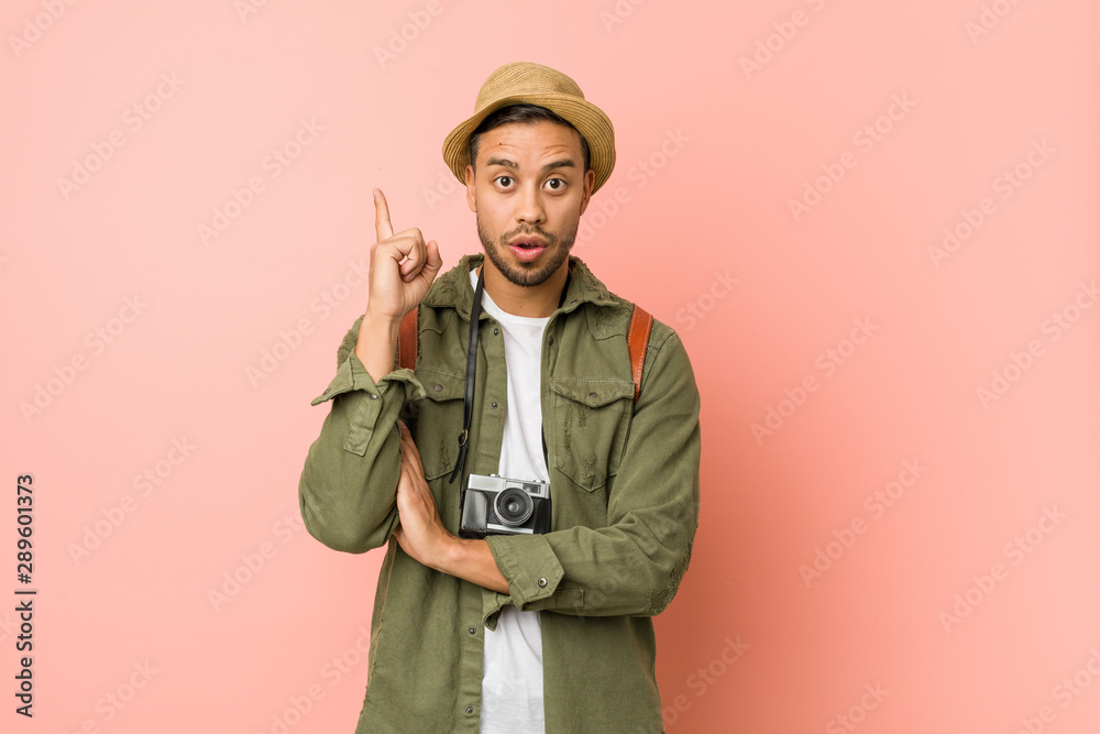 Young filipino traveler man having some great idea, concept of creativity. Young filipino traveler man having some great idea, concept of creativity.