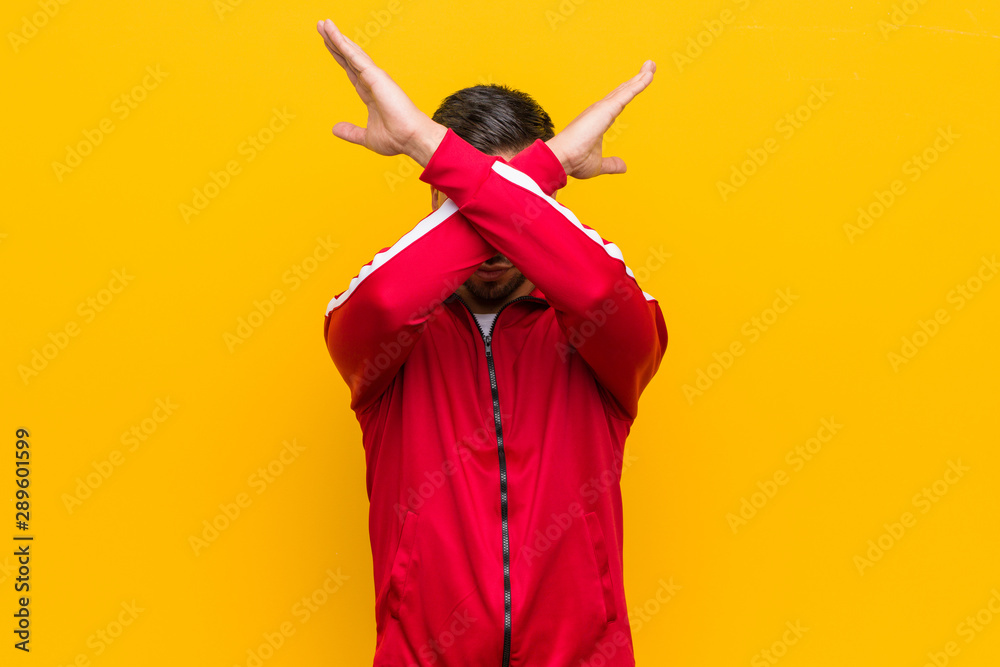 © Asier - Young filipino fitness man keeping two arms crossed, denial concept.