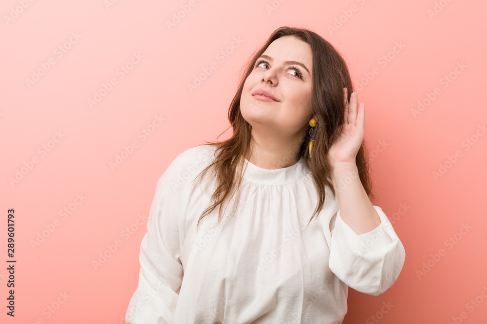 Young caucasian curvy woman standing against pink background Young caucasian curvy woman standing against pink background